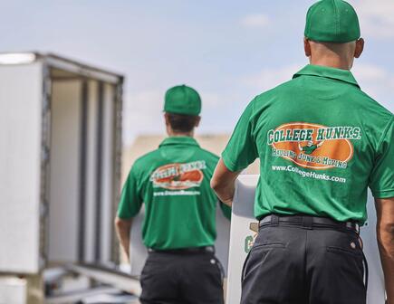 Two college hunks hauling junk